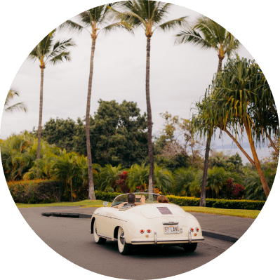 http://A%20classic%20convertible%20sports%20car,%20in%20white,%20with%20the%20top%20down,%20parked%20on%20a%20road%20lined%20with%20palm%20trees.%20The%20scene%20suggests%20a%20warm,%20tropical%20location%20with%20lush%20greenery%20and%20a%20hint%20of%20a%20hill%20in%20the%20distance.