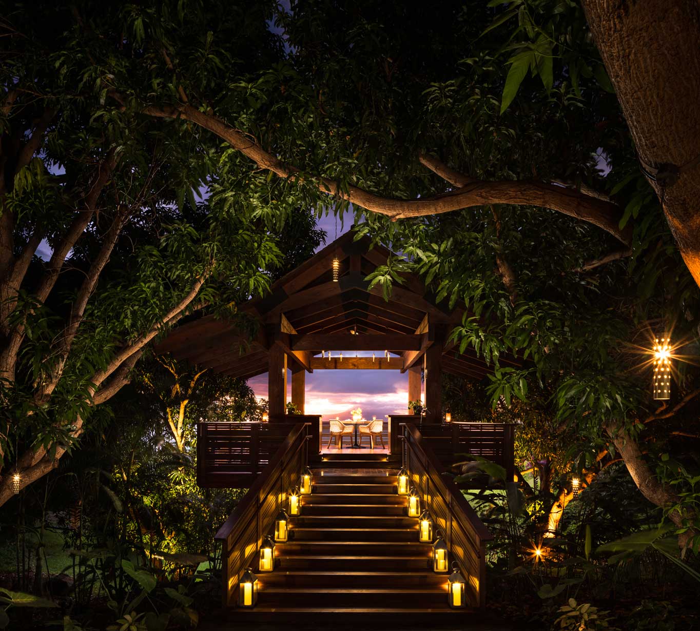 The Treehouse Maui Entrance at night lit by candles and tree lights.